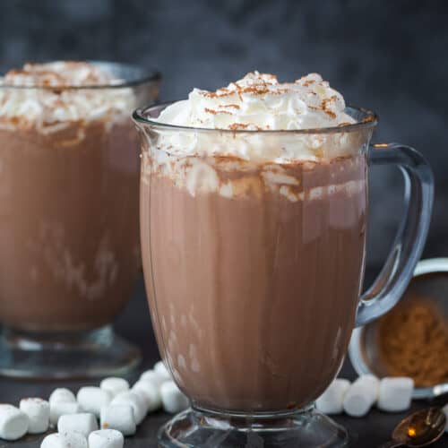 Glass mugs filled with hot chocolate.