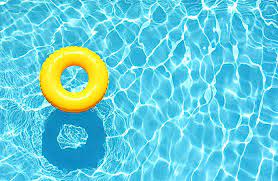 A yellow donut floatie in a blue pool