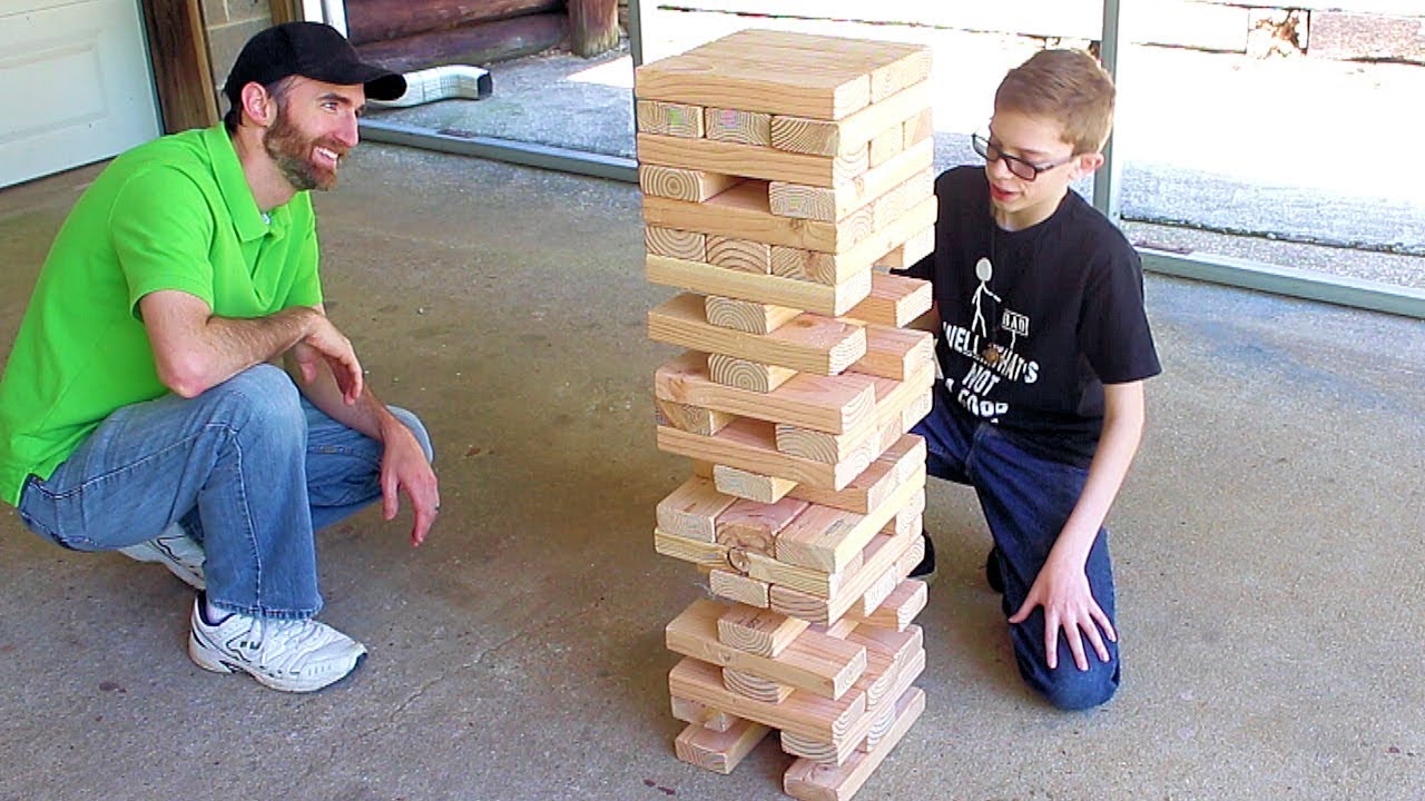 Father and son play giant Jenga