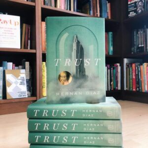 "trust" by Hernan Diaz books stacked together