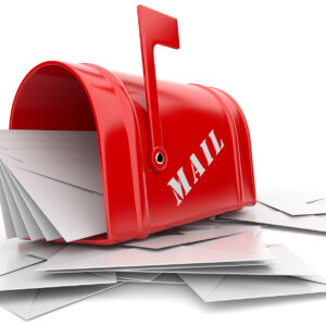 Image of a red mailbox with blank white envelopes spread about.