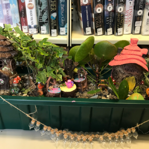 Fairy Garden in front of a bookshelf at the Cheat Area Public Library.