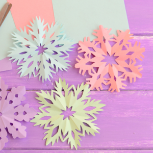 Paper snowflakes with scissors.