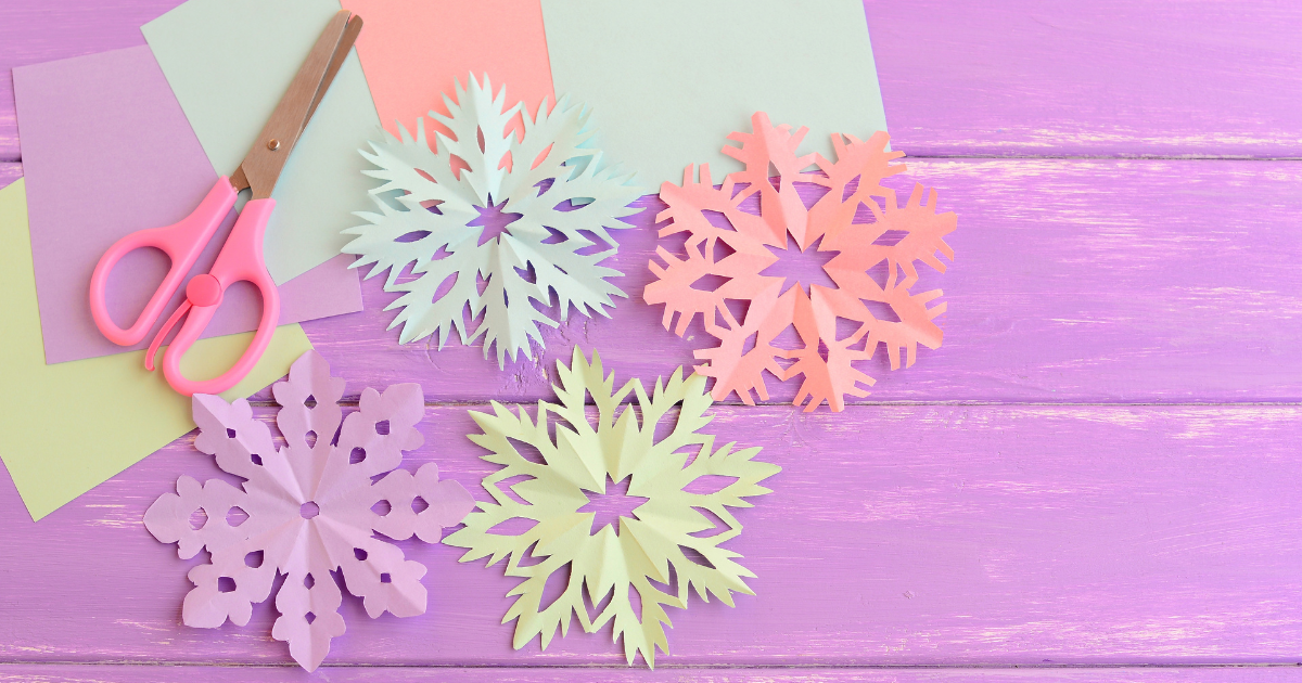 Paper snowflakes with scissors.
